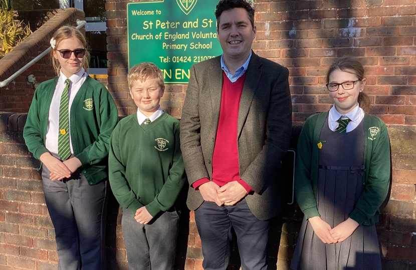 Huw with 3 school council pupils outside St Peter & St Paul School