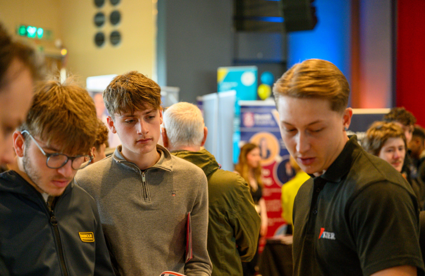 Photo of three young adults talking to Keir Construction (exhibitor)