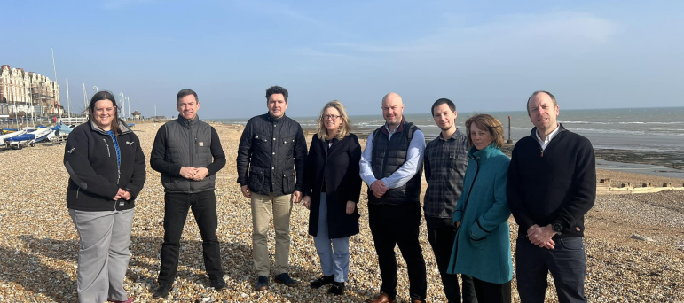 Huw Merriman, Sally-Ann Hart and representatives from Southern Water and EA standing on beach in Bexhill