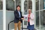Photo of Huw and Christine Bayliss holding Bexhill bus survey document