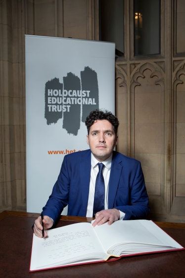 Huw signing Holocaust Memorial Book in Parliament