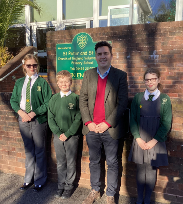 Huw with 3 school council pupils outside St Peter & St Paul School